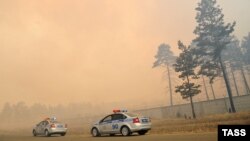 Полицейские автомобили в районе лесных пожаров возле деревни Смоленка в Забайкалье, 13 апреля 2015 года