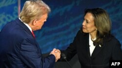 Kamala Harris prezidentlik debatı zamanı Donald Tramp ilə əl sıxır.